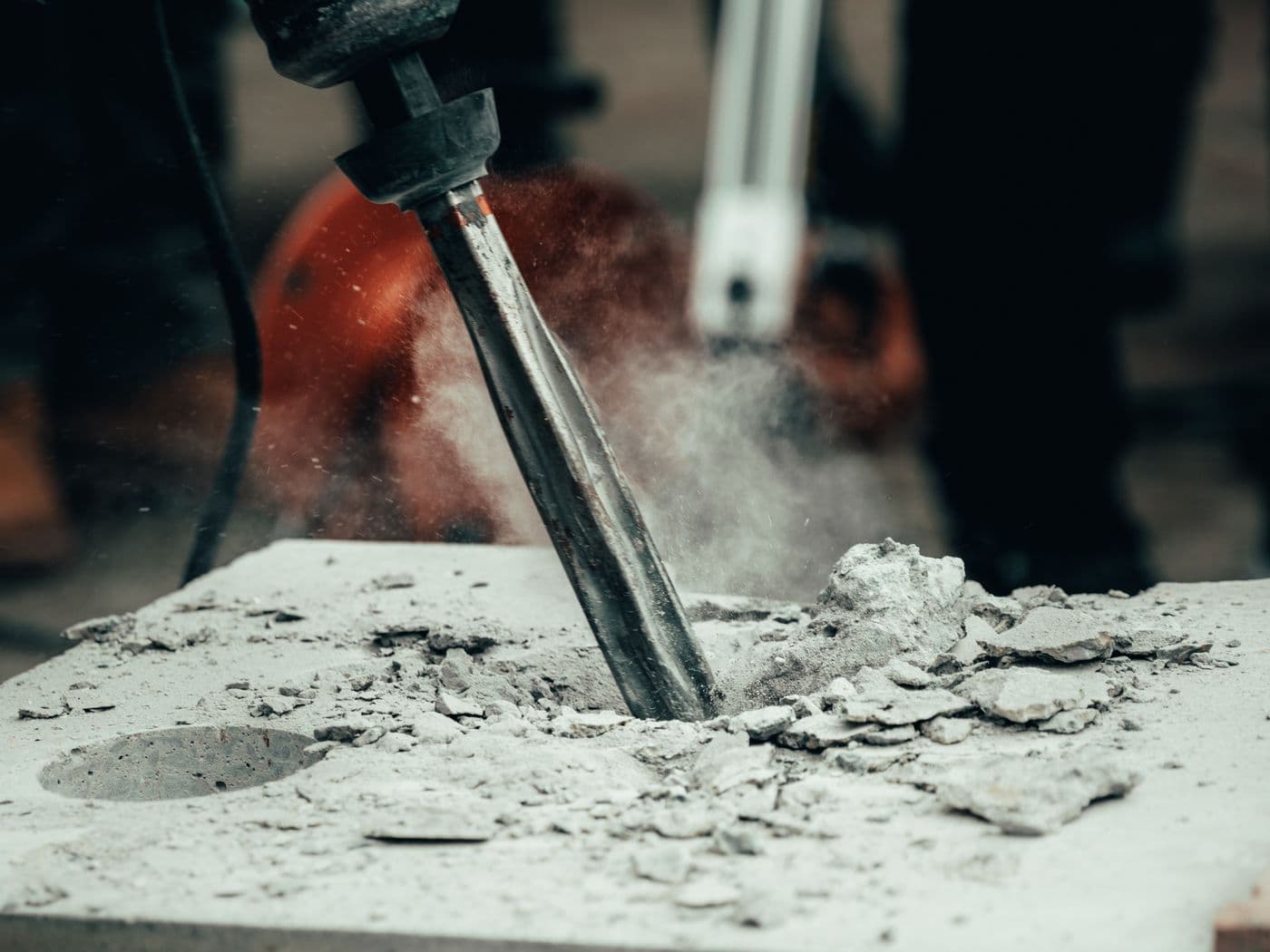 Chisel breaking up a concrete slab